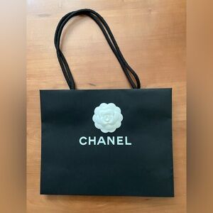 CHANEL Black Bag with White Floral Detail